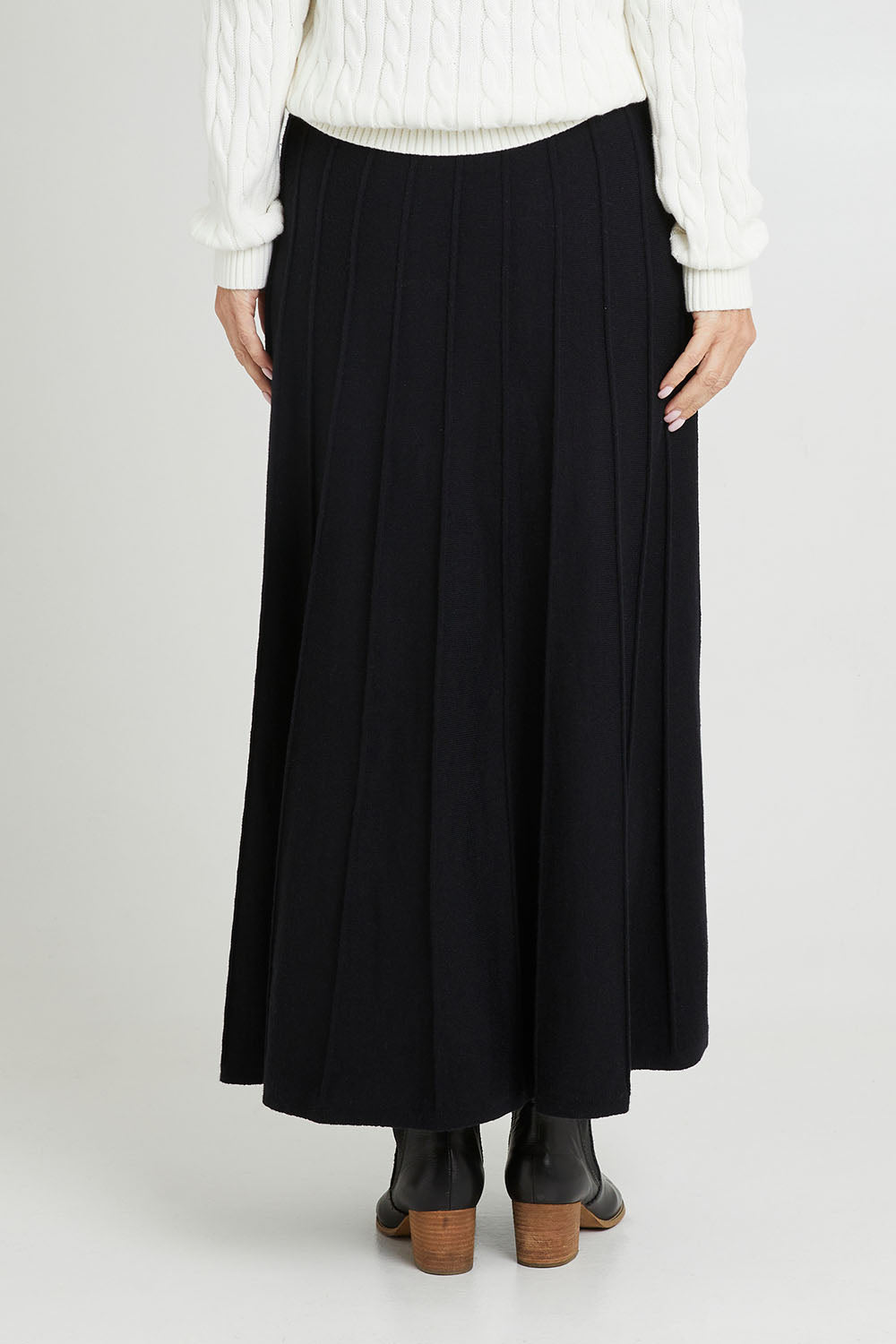Model Luisa wearing size S of the Kate Knit Long Skirt in colour Black (Black), from the back