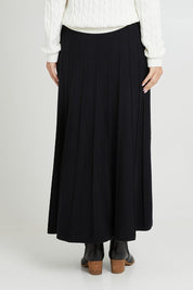 Model Luisa wearing size S of the Kate Knit Long Skirt in colour Black (Black), from the back