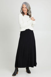Model Luisa wearing size S of the Kate Knit Long Skirt in colour Black (Black), from the front, showing the whole outfit