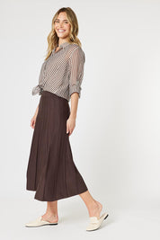 A model wearing the Kate Knit Long Skirt in colour Chocolate, from the front, showing the whole outfit