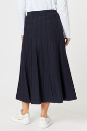 A model wearing the Kate Knit Long Skirt in colour Navy (Blue), from the back