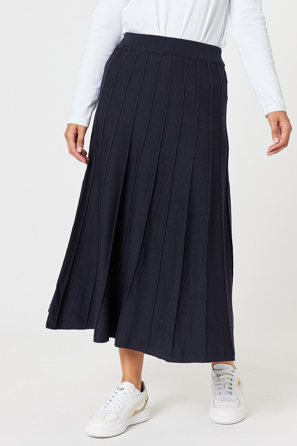A model wearing the Kate Knit Long Skirt in colour Navy (Blue), from the front, cropped image