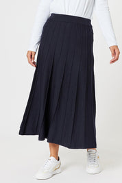 A model wearing the Kate Knit Long Skirt in colour Navy (Blue), from the front, cropped image