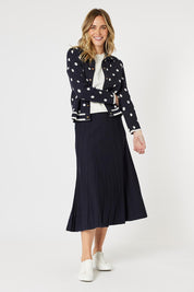A model wearing the Kate Knit Long Skirt in colour Navy (Blue), from the front, showing the whole outfit