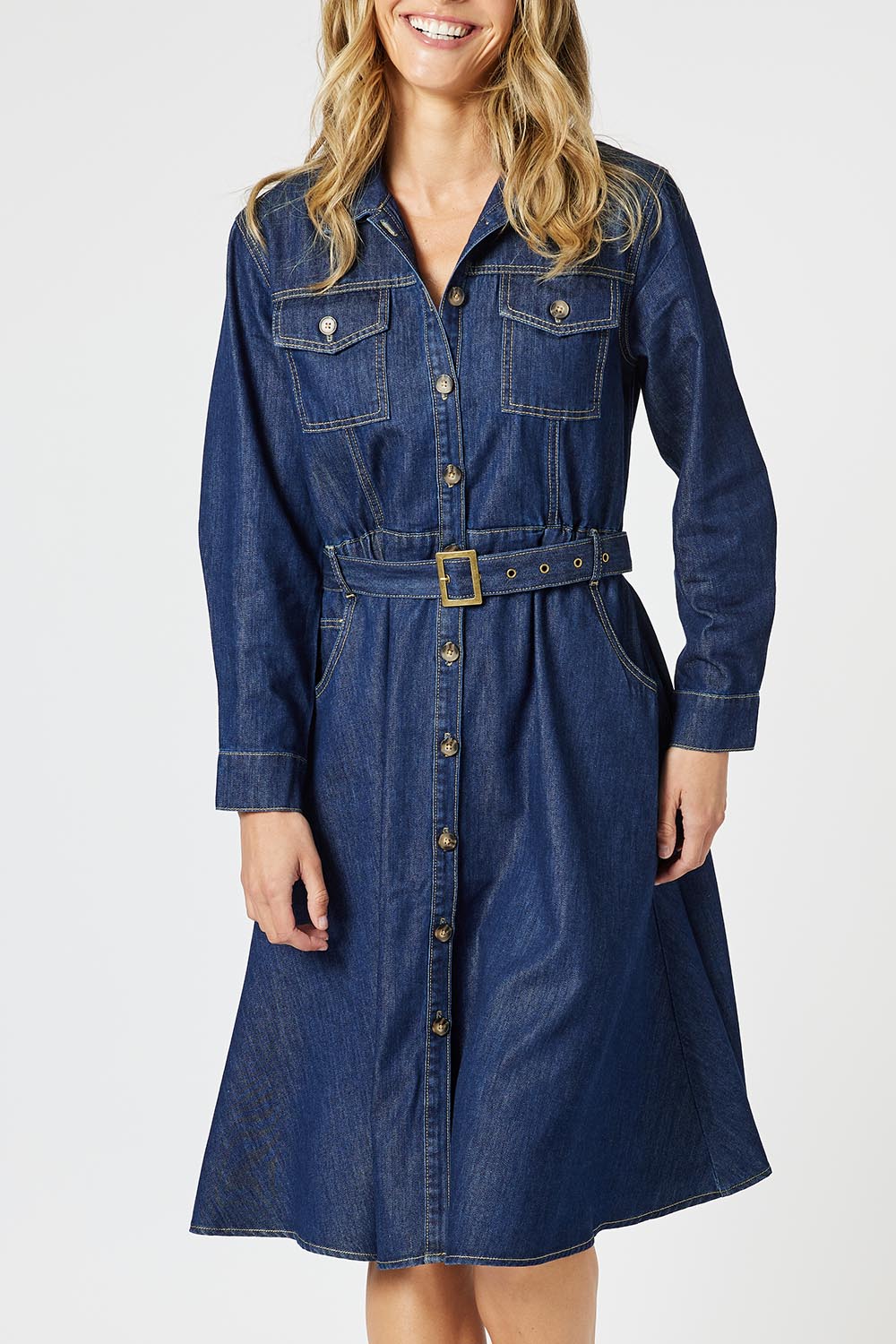 A model wearing the Capetown Denim Dress in colour Denim (Blue), from the front, cropped image