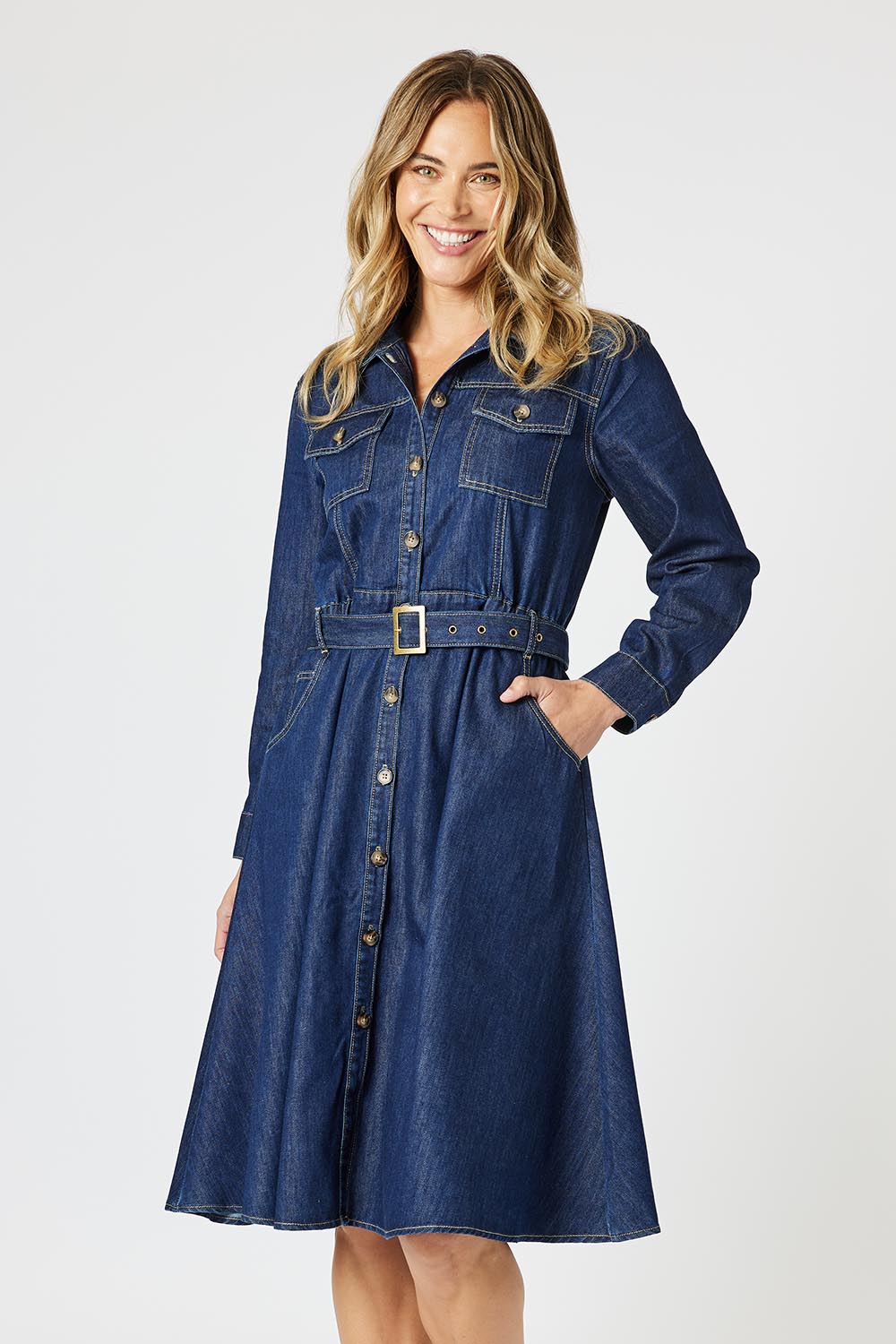 A model wearing the Capetown Denim Dress in colour Denim (Blue), from the front, cropped image