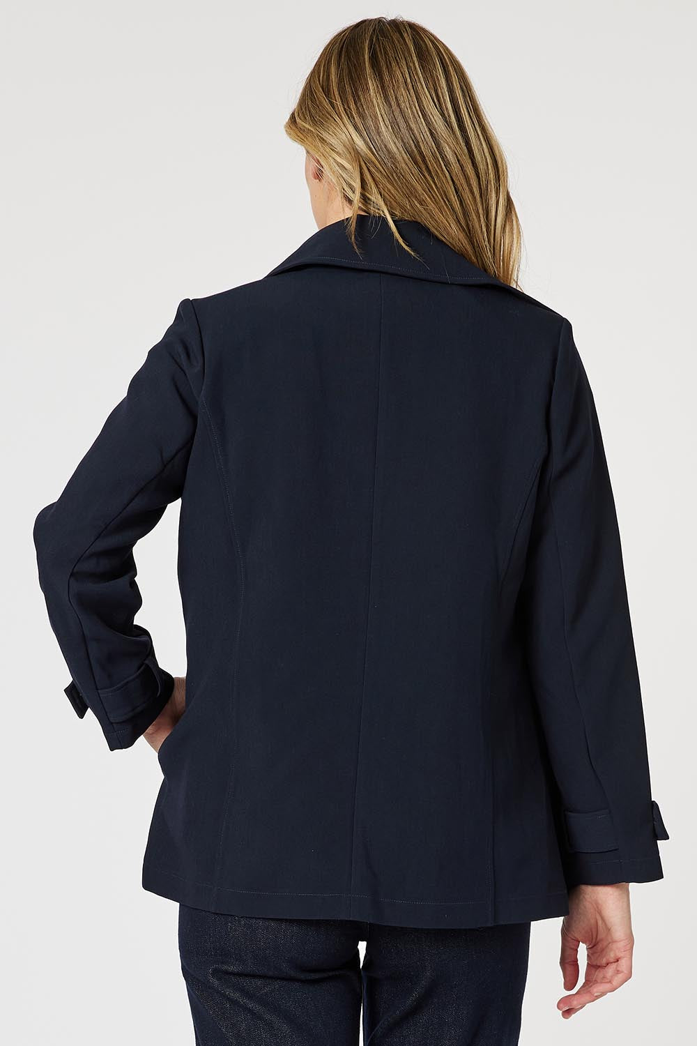 A model wearing the Chelsea Jacket in colour Navy (Blue), from the back