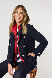 A model wearing the Chelsea Jacket in colour Navy (Blue), from the front, cropped image