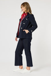 A model wearing the Chelsea Jacket in colour Navy (Blue), from the front, showing the whole outfit
