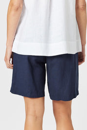 A model wearing the Lino Linen Blend Shorts in colour Navy (Blue), from the front, cropped image
