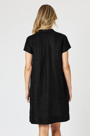 A model wearing the Delta Lino Linen Blend Dress in colour Black (Black), from the back
