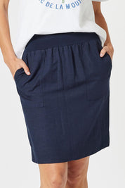 A model wearing the Lino Linen Blend Skirt in colour Navy (Blue), from the front, cropped image