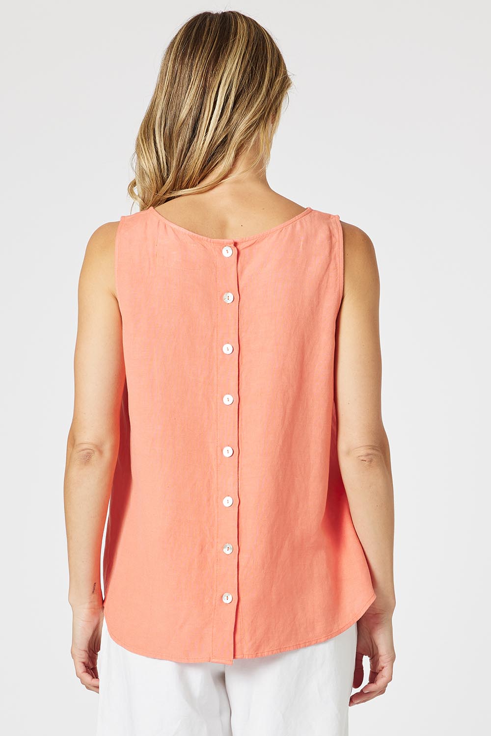 A model wearing the Lino Linen Blend Button Back Cami in colour Papaya, from the back