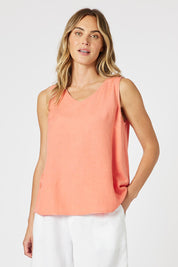 A model wearing the Lino Linen Blend Button Back Cami in colour Papaya, from the front, cropped image