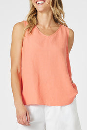 A model wearing the Lino Linen Blend Button Back Cami in colour Papaya, from the front, cropped image