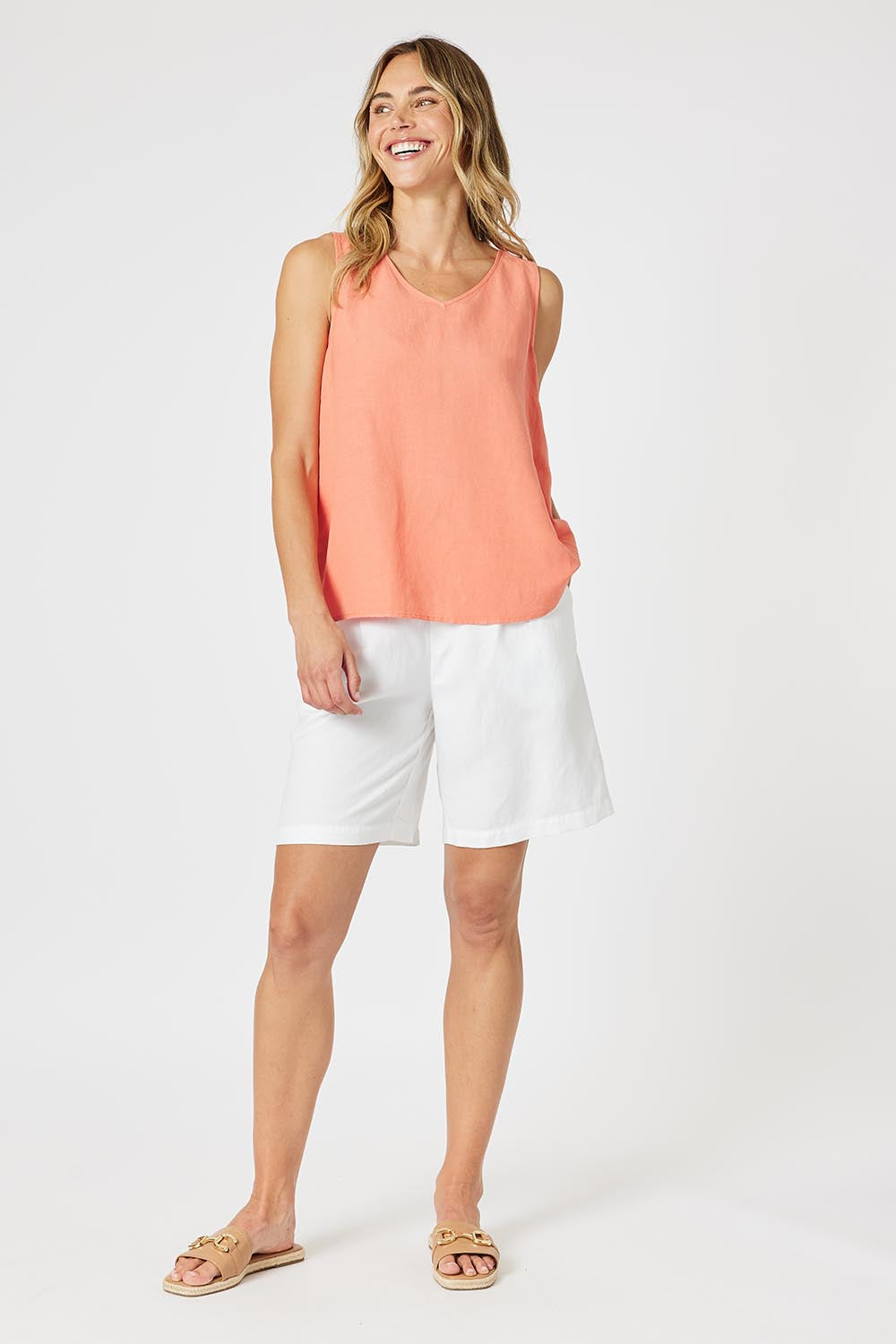 A model wearing the Lino Linen Blend Button Back Cami in colour Papaya, from the front, showing the whole outfit