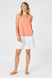 A model wearing the Lino Linen Blend Button Back Cami in colour Papaya, from the front, showing the whole outfit