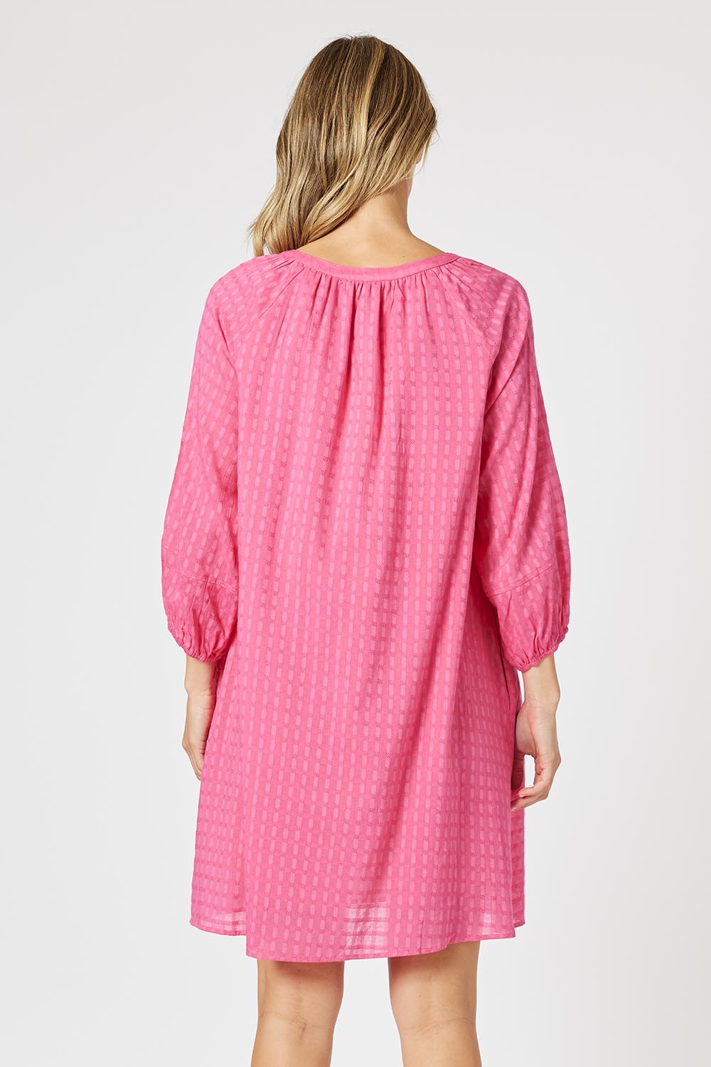 A model wearing the Mykonos Cotton Check Dress in colour Peony (Pink), from the back