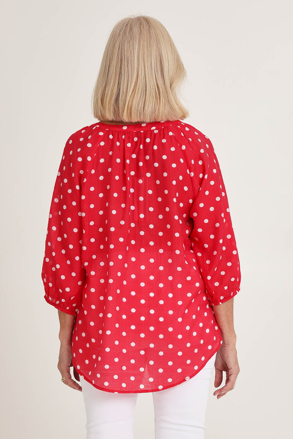 Model Sandy wearing size 10 of the French Rose Blouse in colour Red (Red), from the back
