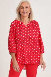 Model Sandy wearing size 10 of the French Rose Blouse in colour Red (Red), from the front, cropped image