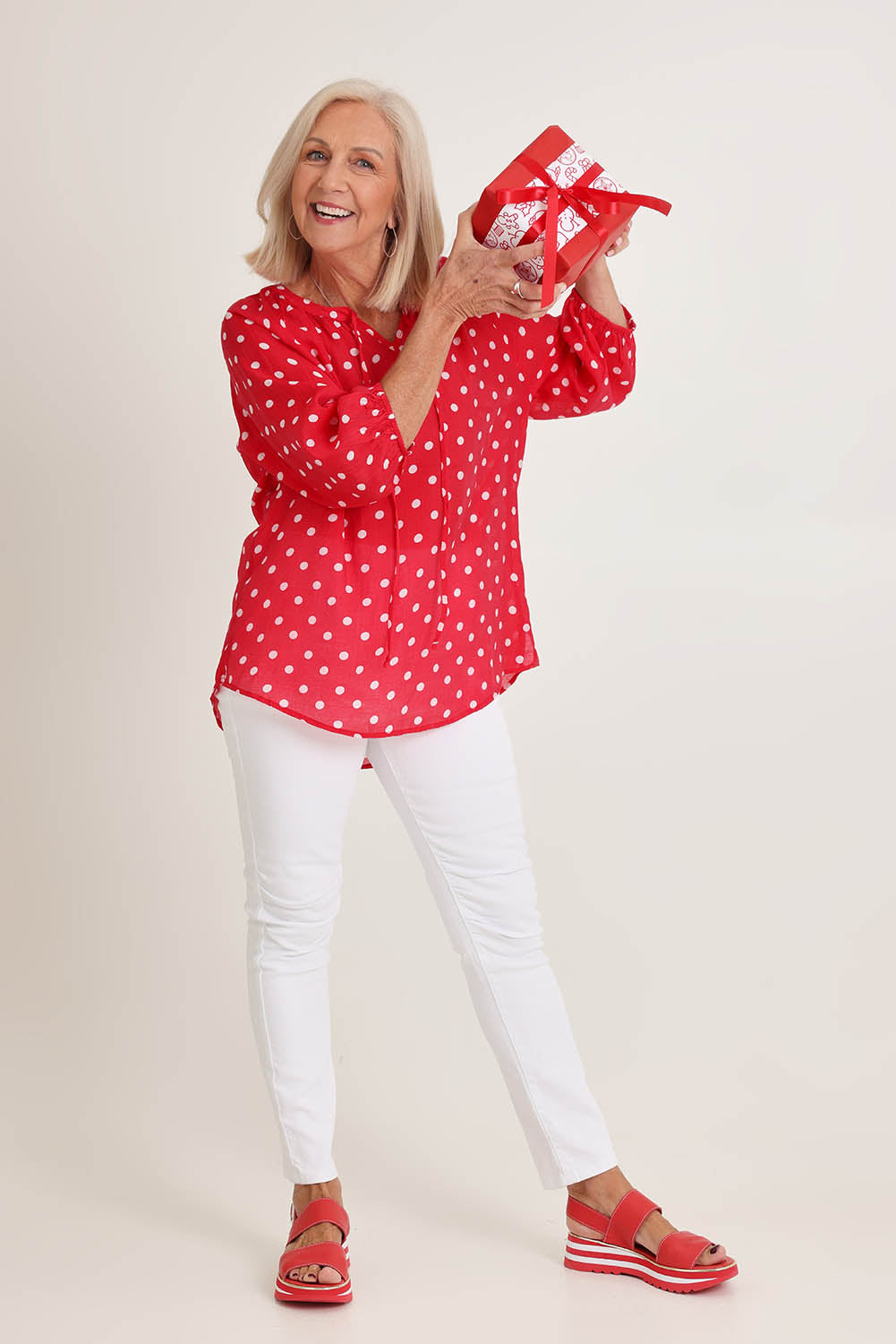 Model Sandy wearing size 10 of the French Rose Blouse in colour Red (Red), from the front, showing the whole outfit