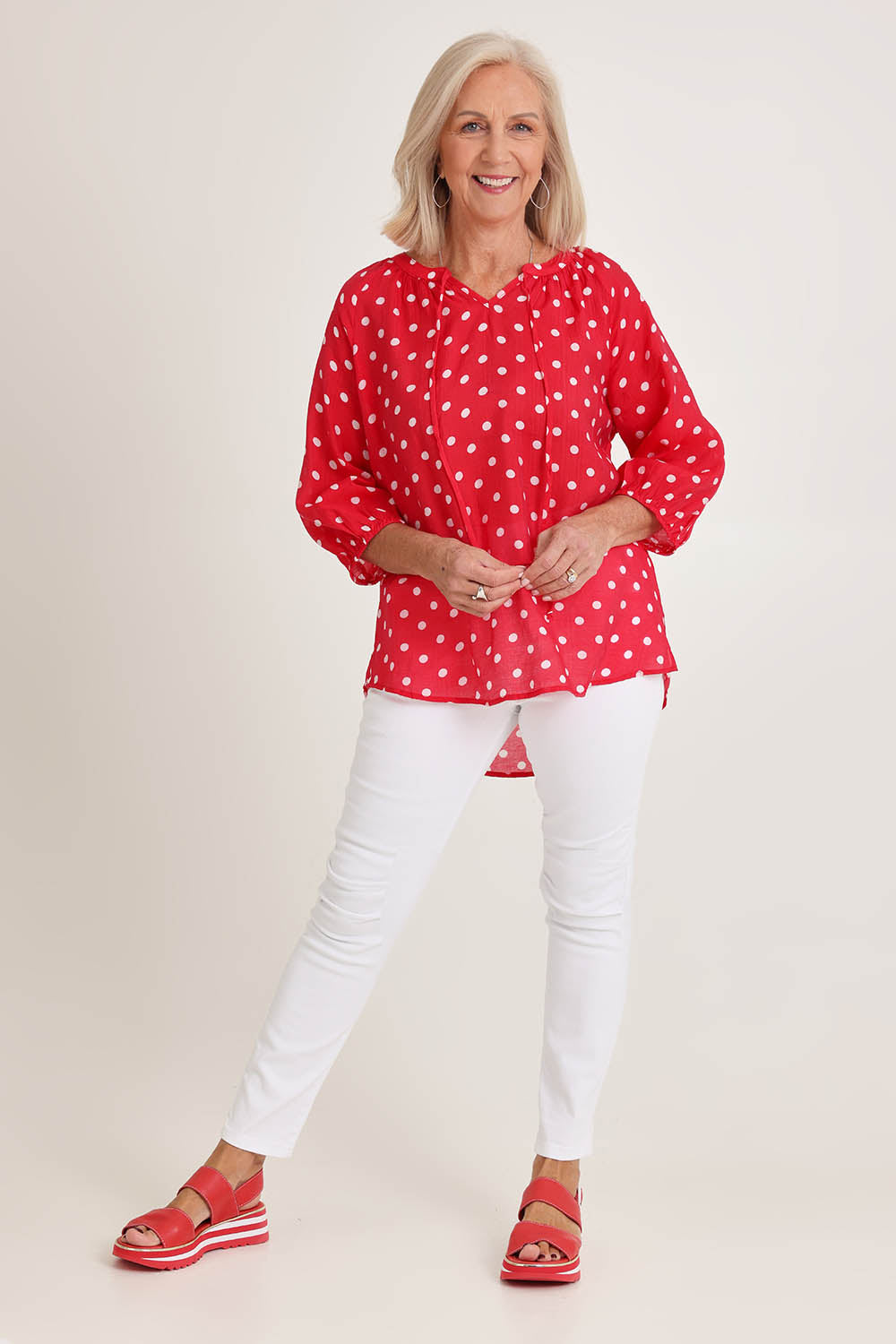 Model Sandy wearing size 10 of the French Rose Blouse in colour Red (Red), from the front, showing the whole outfit