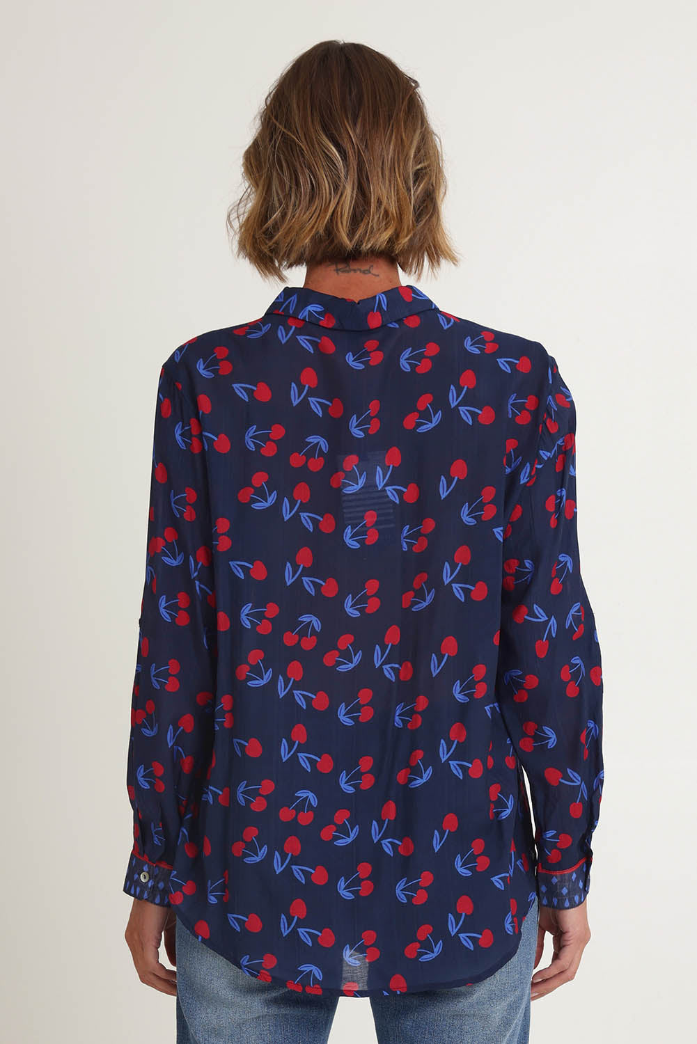 Model Riina wearing size 10 of the Cherry Delight Shirt in colour Navyred (Blue), from the back
