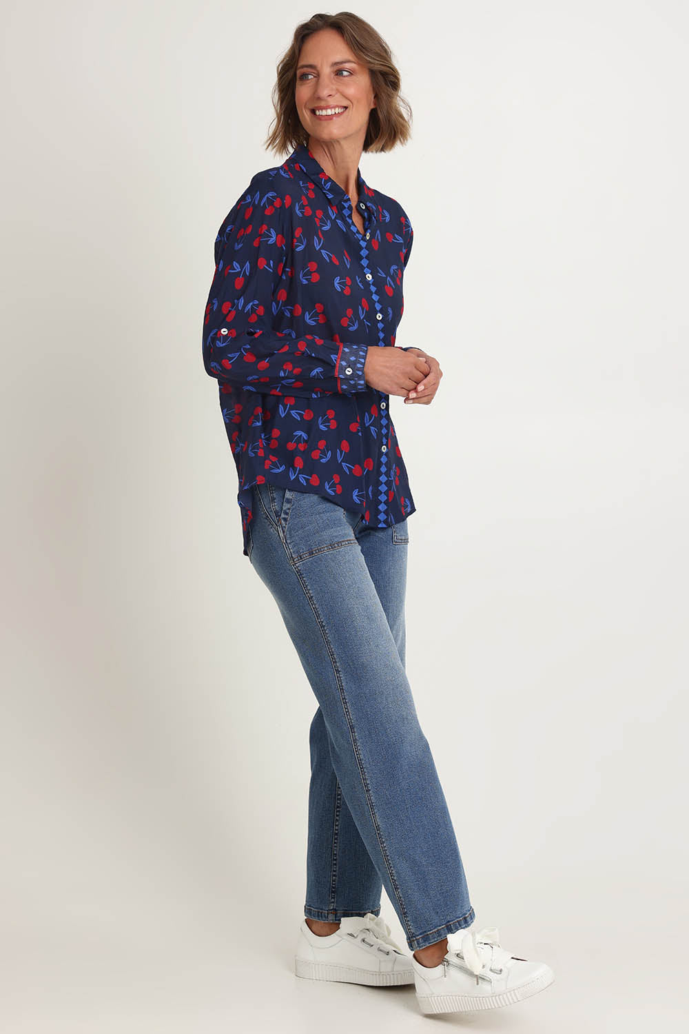 Model Riina wearing size 10 of the Cherry Delight Shirt in colour Navyred (Blue), from the front, showing the whole outfit