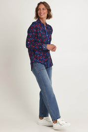 Model Riina wearing size 10 of the Cherry Delight Shirt in colour Navyred (Blue), from the front, showing the whole outfit