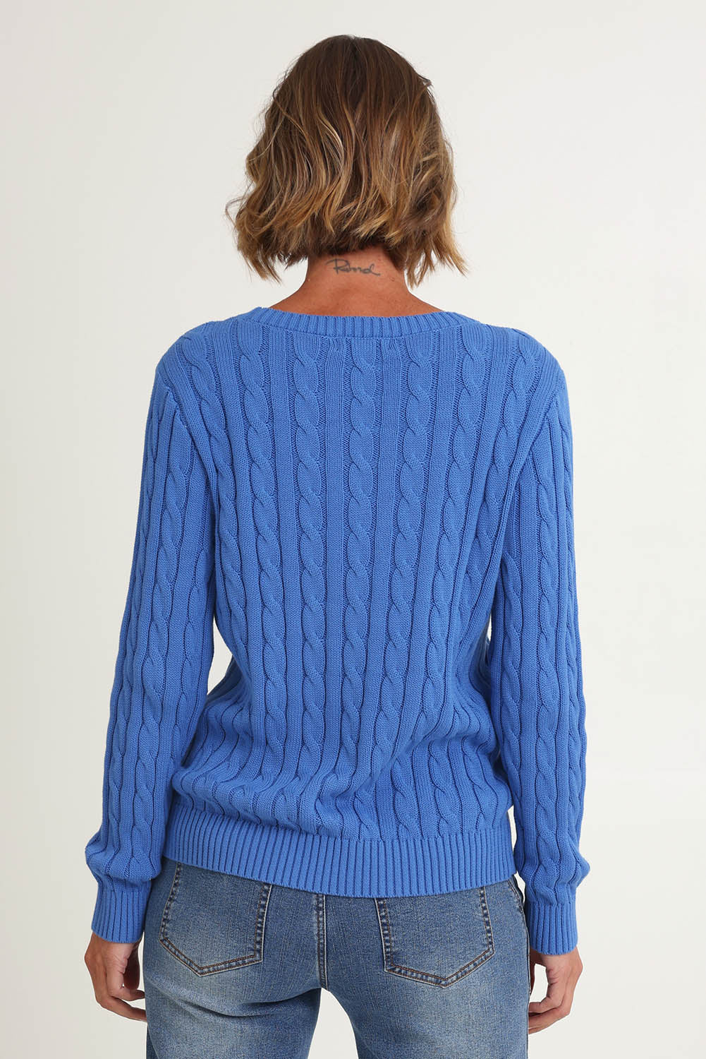 Model Riina wearing size S of the Hampton Cable Knit Jumper in colour Cobalt (Blue), from the back