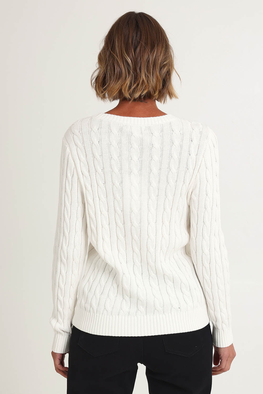 Model Riina wearing size S of the Hampton Cable Knit Jumper in colour Ivory (White), from the back