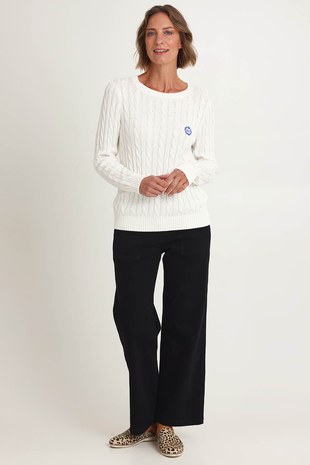 Model Riina wearing size S of the Hampton Cable Knit Jumper in colour Ivory (White), from the front, showing the whole outfit