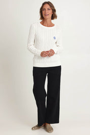Model Riina wearing size S of the Hampton Cable Knit Jumper in colour Ivory (White), from the front, showing the whole outfit