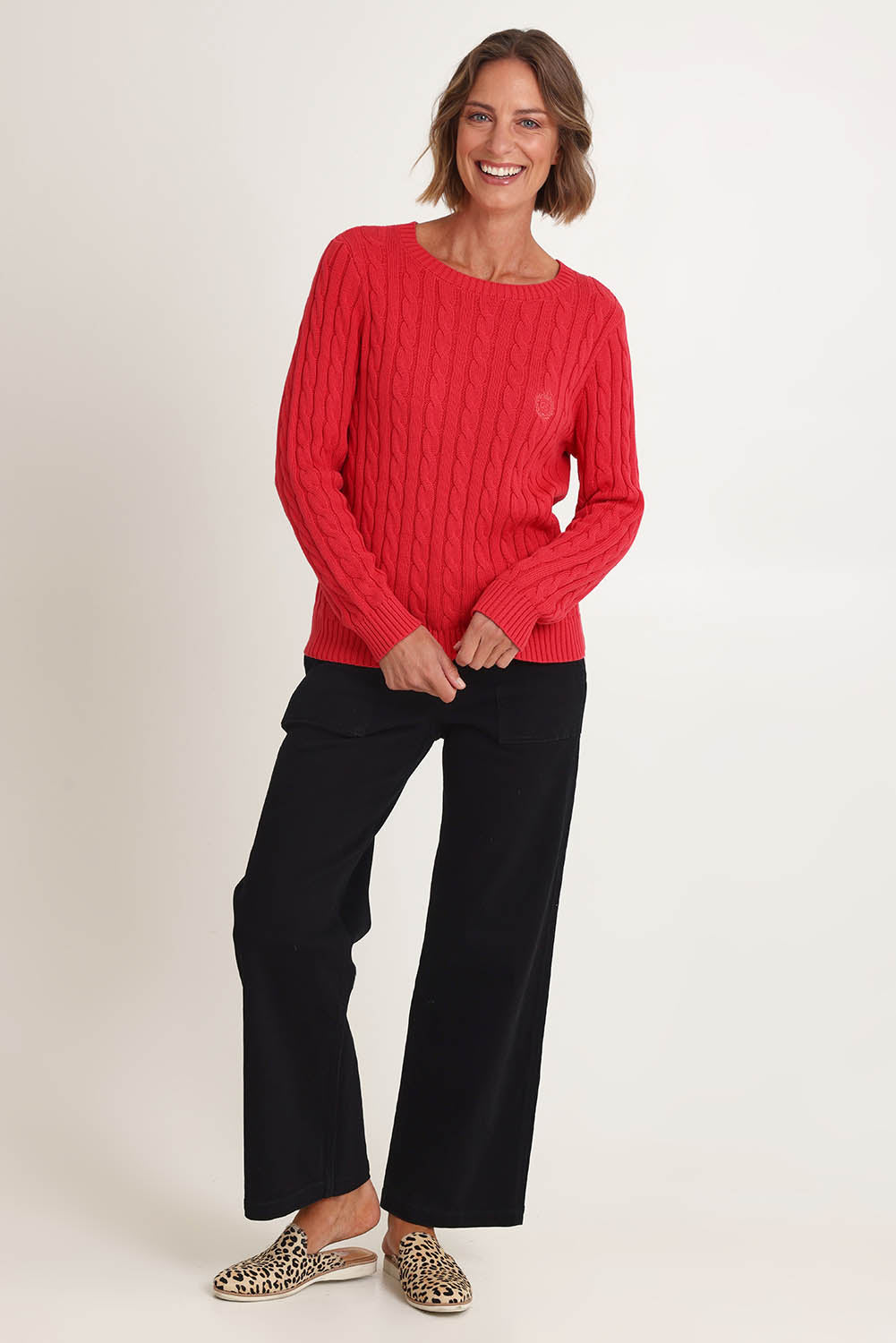 Model Riina wearing size S of the Hampton Cable Knit Jumper in colour Red (Red), from the front, showing the whole outfit