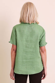 Model Sandys wearing size 10 of the Audrey Ruffle Linen Top - Fern in colour Fern, from the back