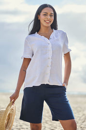 Model Eshan wearing size 10 of the Audrey Ruffle Linen Top - White in colour White, in a cropped view