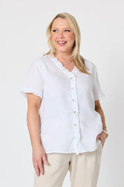 Model Genericm wearing size sample of the Audrey Ruffle Linen Top - White in colour White, in a cropped view