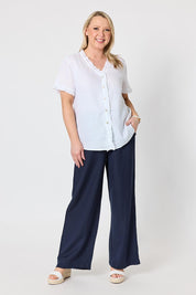 Model Genericm wearing size sample of the Audrey Ruffle Linen Top - White in colour White, from the front