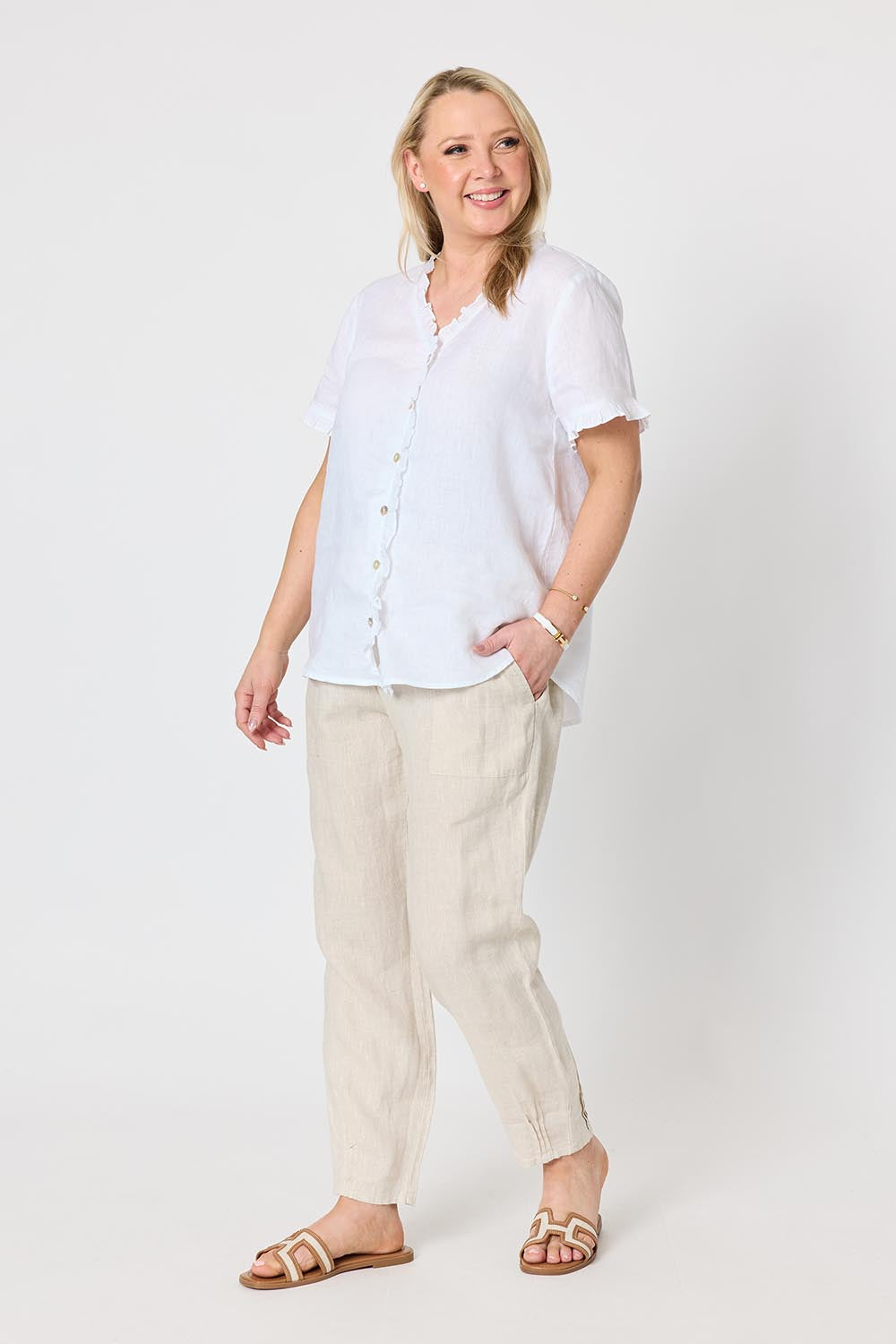 Model Genericm wearing size sample of the Audrey Ruffle Linen Top - White in colour White, from the front