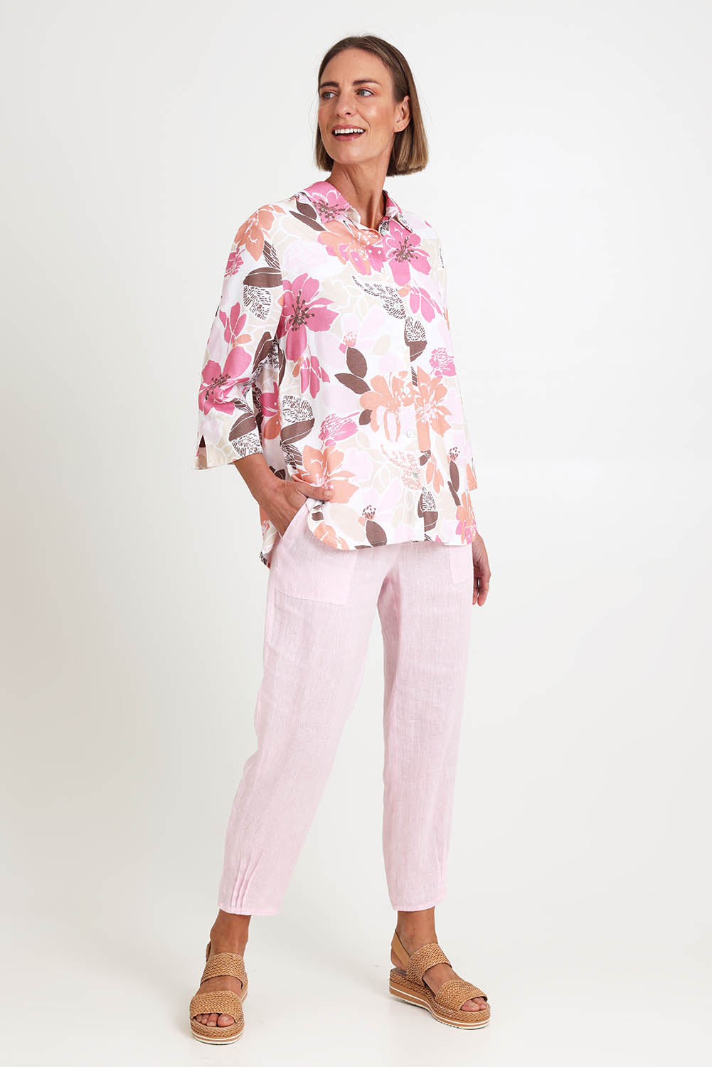 Model Riinar wearing size 10 of the Amalfi Rose Print Shirt – Pinkmulti in colour Pinkmulti, from the front
