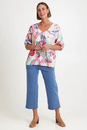 Model Riinar wearing size 10 of the Desert Rose Print Top – Pinkmulti in colour Pinkmulti, from the front