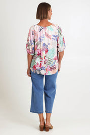 Model Riinar wearing size 10 of the Desert Rose Print Top – Pinkmulti in colour Pinkmulti, from the front
