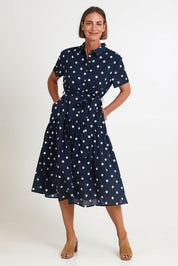 Model Riinar wearing size 10 of the Riviera Spot Dress – Navywhite in colour Navywhite, from the front
