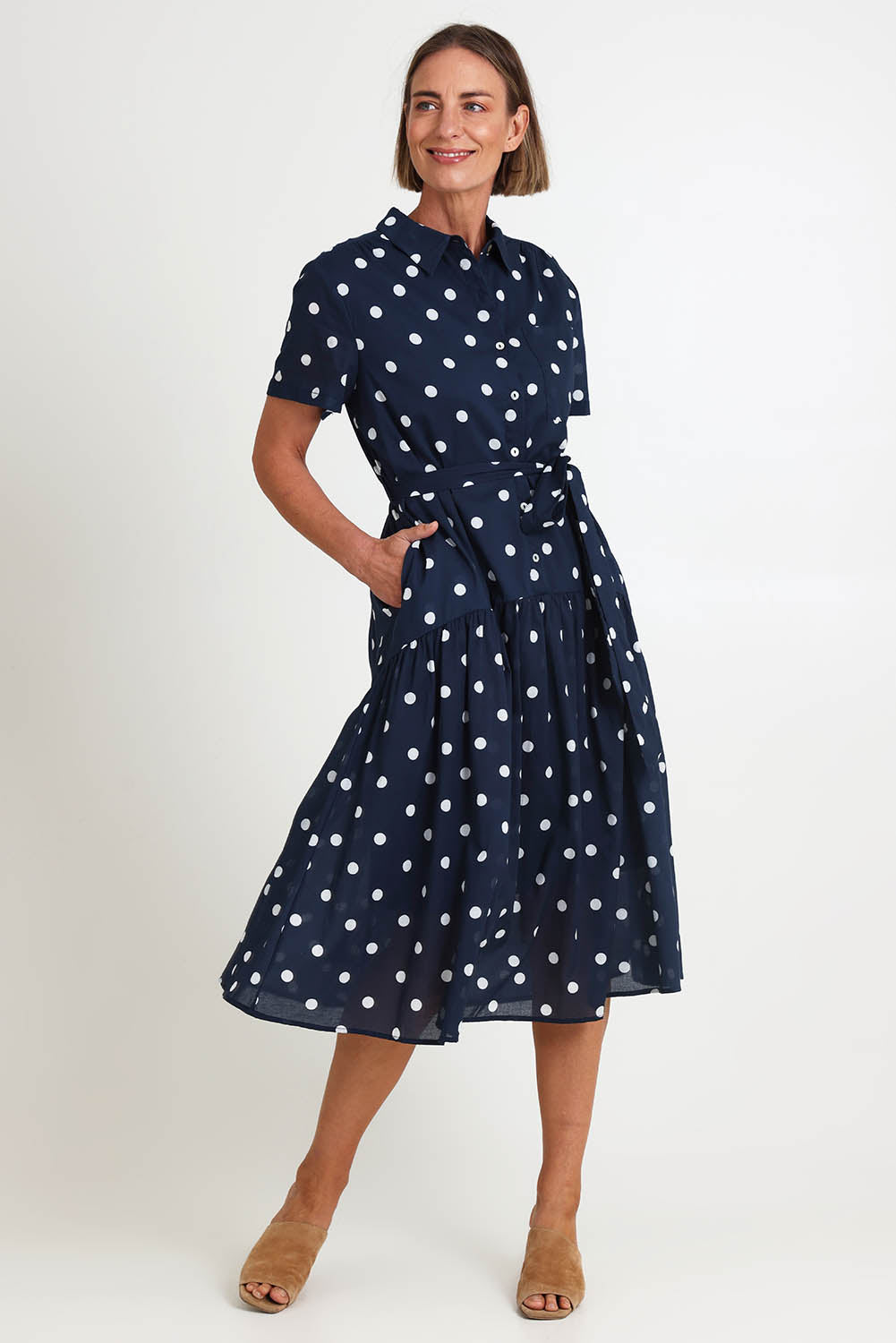 Model Riinar wearing size 10 of the Riviera Spot Dress – Navywhite in colour Navywhite, from the front