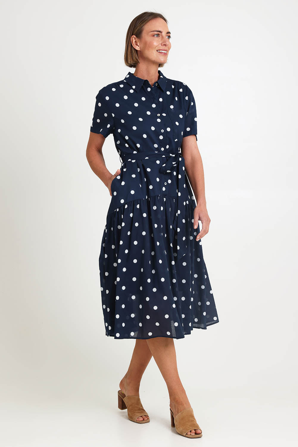 Model Riinar wearing size 10 of the Riviera Spot Dress – Navywhite in colour Navywhite, from the front