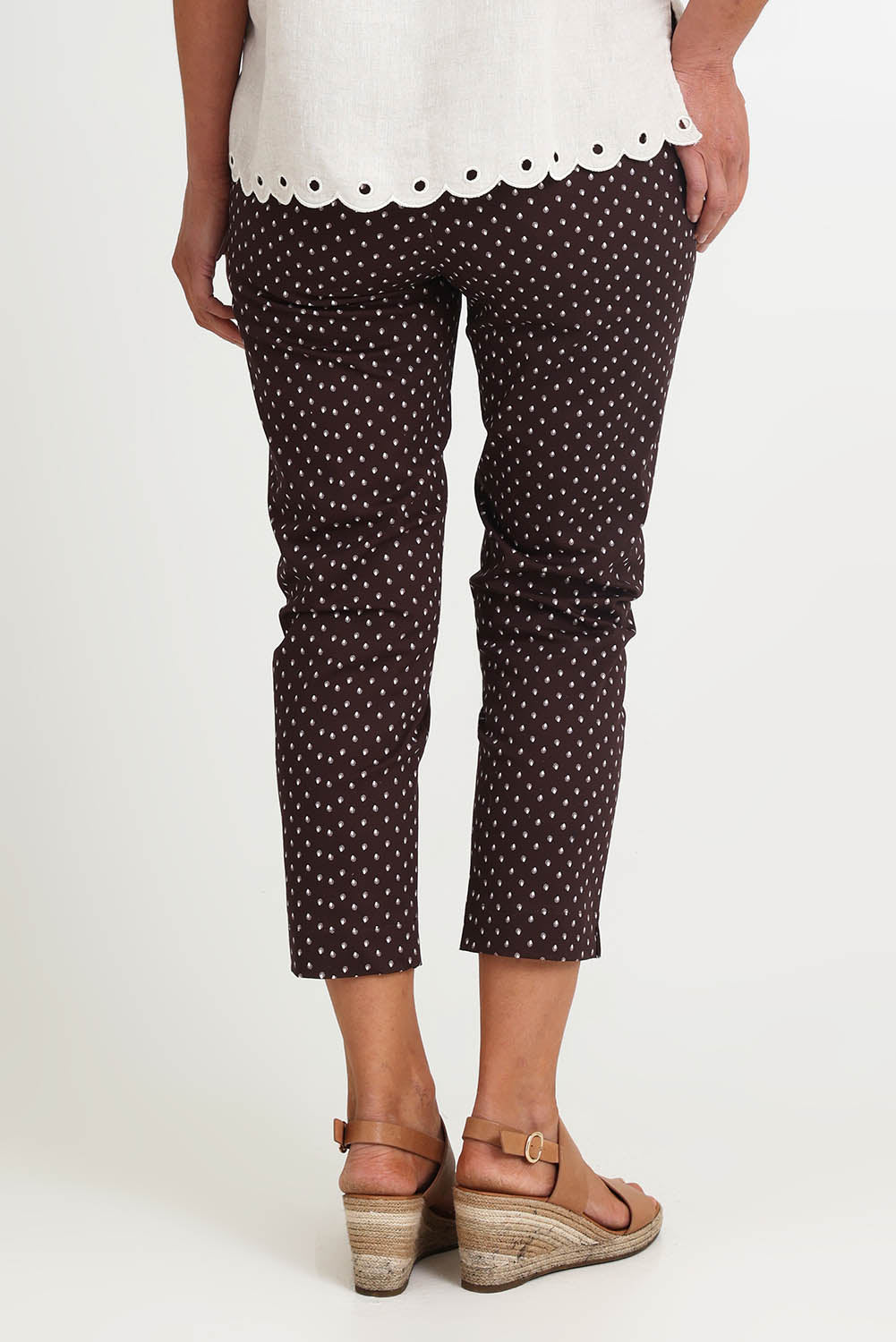 Model Riinar wearing size 10 of the Shell Print Pant – Mocha in colour Mocha, from the back