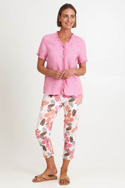 Model Riinar wearing size 10 of the Amalfi Rose Print Pant – Pinkmulti in colour Pinkmulti, from the front