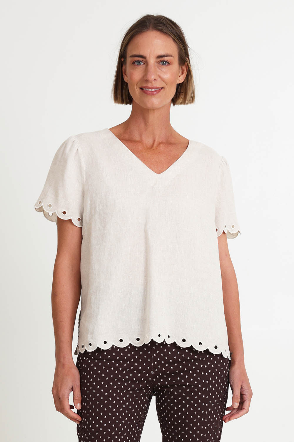 Model Riinar wearing size 10 of the Lilly Linen Top – Natural in colour Natural, in a cropped view