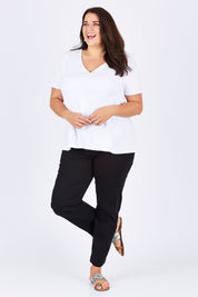 Model Mae wearing size 18 of the Slim Miracle Denim Jeans in colour Black (Black), from the front, showing the whole outfit