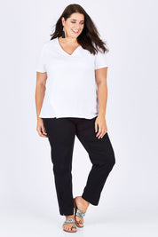 Model Mae wearing size 18 of the Slim Miracle Denim Jeans in colour Black (Black), from the front, showing the whole outfit